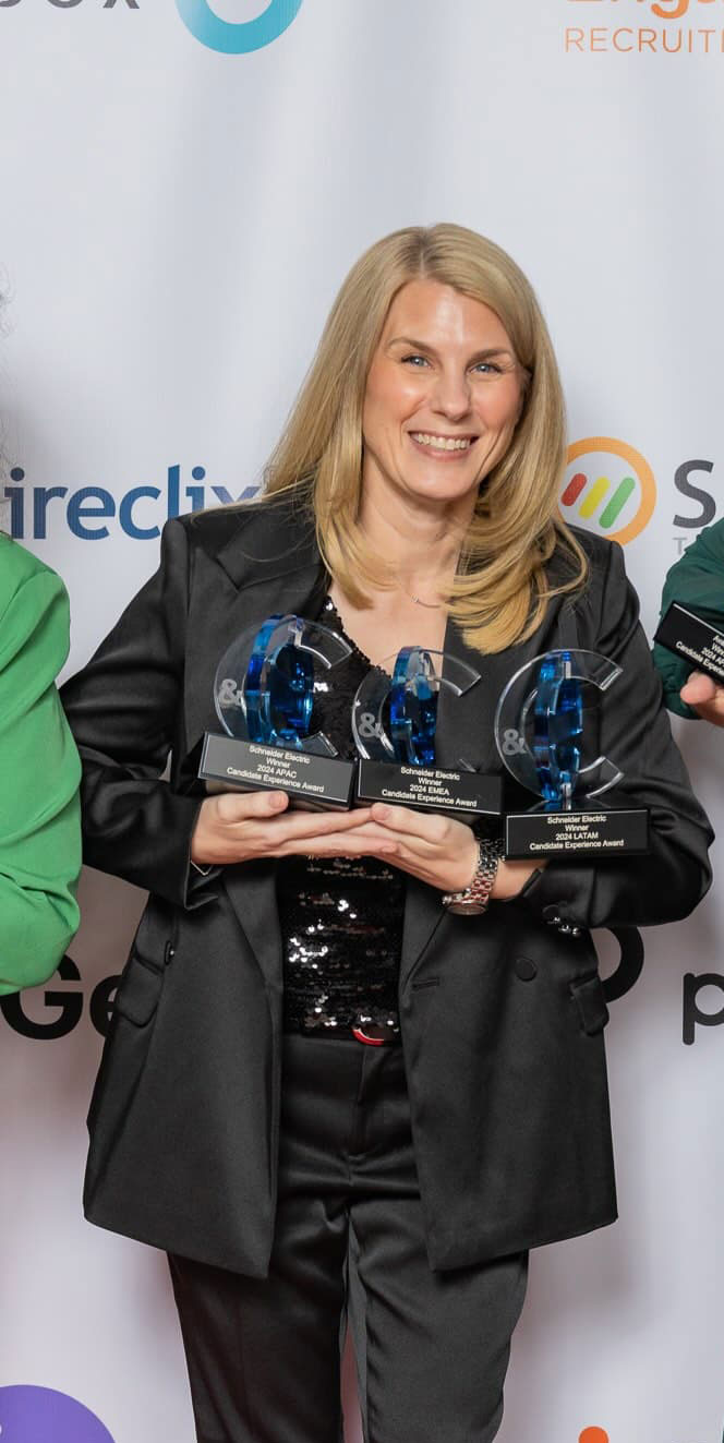 CandE Award winner holding Candidate Experience Award trophies